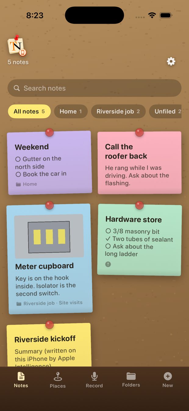 The TackNote board on an iPhone, showing coloured notes on cork with folders across the top.
